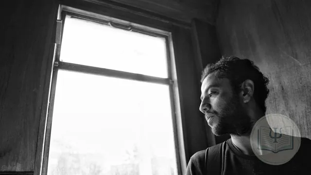 Bipolar disorder: a person between light and shadow by a window